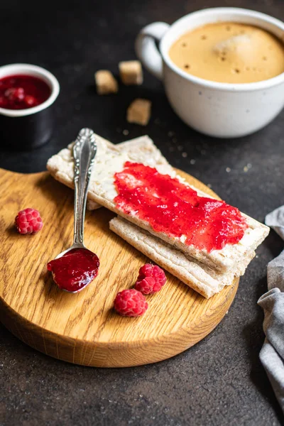 jam sandwich and cup of coffee berry jam, butter, organic whole grain diet bread crisp on the table, healthy food meal snack copy space food background rustic. top view