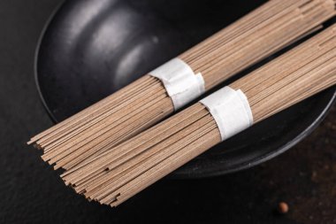 Soba karabuğday eriştesi, arka plandaki fotokopi masasında porsiyon yemek aperatifi pişirmeye hazır. Top view keto ya da paleo diyet vejetaryen ya da vejetaryen yemekleri