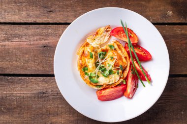 Omlet sebzeler kızarmış yumurta taze kahvaltı salatası domates, salatalık taze porsiyon masada atıştırmaya hazır sebzeler. 