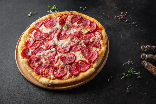 Pizza salamı ya da pepperoni sosisi, peynir, domates sosu, hamur taze porsiyon yemek için hazır. en üstteki görünüm