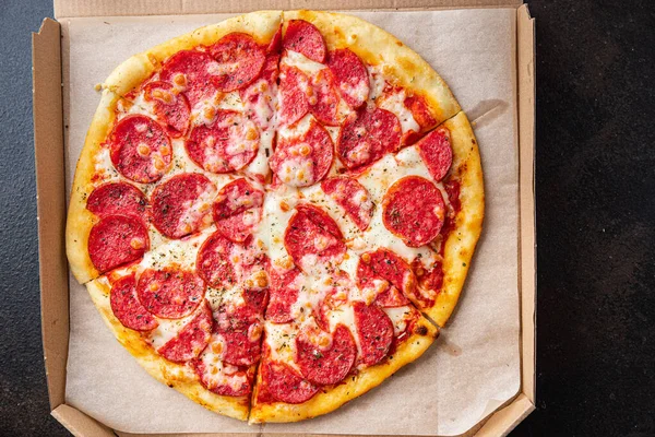 Pizza salamı ya da pepperoni sosisi, peynir, domates sosu, hamur taze porsiyon yemek için hazır. en üstteki görünüm