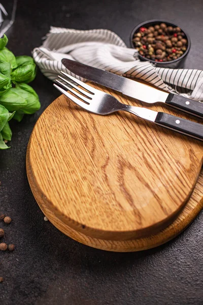 wooden serving board and cutlery fork and knife zero waste meal on the table copy space food background rustic. top view