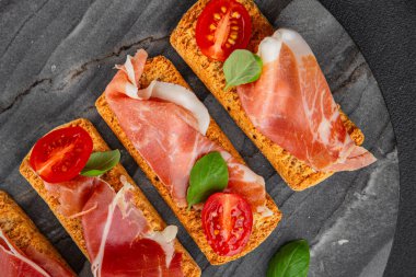 jamon bruschetta prosciutto appetizer portioned tapas dish natural tasty snack fresh delicious gourmet food background on the table rustic top view copy space