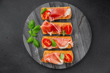 jamon bruschetta prosciutto appetizer portioned tapas dish natural tasty snack fresh delicious gourmet food background on the table rustic top view copy space