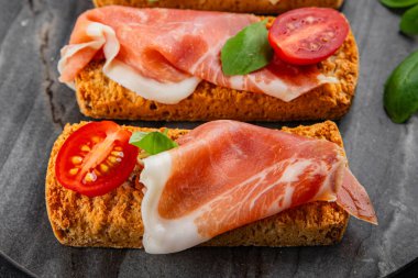jamon bruschetta prosciutto appetizer portioned tapas dish natural tasty snack fresh delicious gourmet food background on the table rustic top view copy space