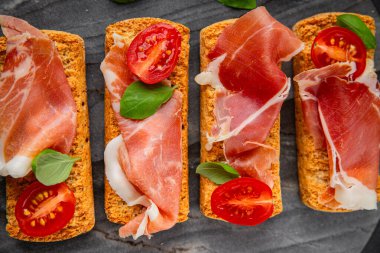 jamon bruschetta prosciutto appetizer portioned tapas dish natural tasty snack fresh delicious gourmet food background on the table rustic top view copy space