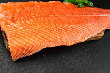 Salmon fillet raw red fish seafood dish natural tasty snack fresh delicious gourmet food background on the table rustic top view copy space pescetarian diet