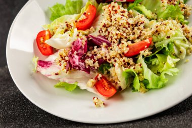 Kinoa salatası domates, yeşil yaprak salatası sebzeler... doğal ürün... lezzetli çerez... lezzetli gurme yemek... masanın üstünde... rustik üst görünüm... fotokopi alanı keto... ve paleo diyet vegan ve vejetaryen yiyecekler.