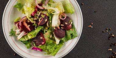 Beet salad green leaf lettuce vegetables natural product tasty snack fresh delicious gourmet food background on the table rustic top view copy space keto and paleo diet vegan and vegan food