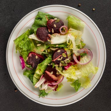 Beet salad green leaf lettuce vegetables natural product tasty snack fresh delicious gourmet food background on the table rustic top view copy space keto and paleo diet vegan and vegan food