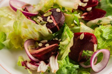 Beet salad green leaf lettuce vegetables natural product tasty snack fresh delicious gourmet food background on the table rustic top view copy space keto and paleo diet vegan and vegan food