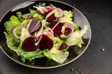 Beet salad green leaf lettuce vegetables natural product tasty snack fresh delicious gourmet food background on the table rustic top view copy space keto and paleo diet vegan and vegan food