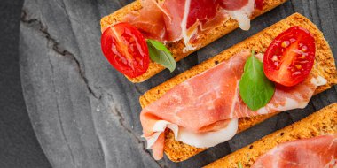 jamon bruschetta prosciutto appetizer portioned tapas dish natural tasty snack fresh delicious gourmet food background on the table rustic top view copy space