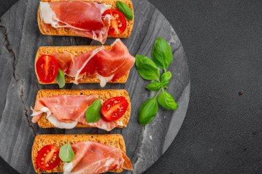 jamon bruschetta prosciutto appetizer portioned tapas dish natural tasty snack fresh delicious gourmet food background on the table rustic top view copy space