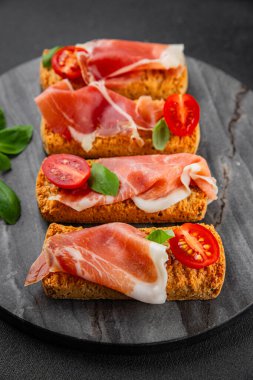 jamon bruschetta prosciutto appetizer portioned tapas dish natural tasty snack fresh delicious gourmet food background on the table rustic top view copy space