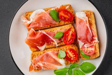 jamon bruschetta prosciutto appetizer portioned tapas dish natural tasty snack fresh delicious gourmet food background on the table rustic top view copy space