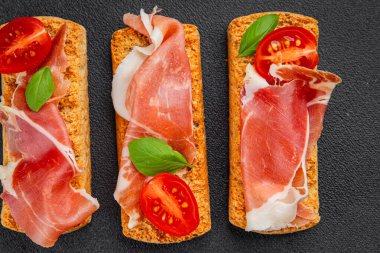 jamon bruschetta prosciutto appetizer portioned tapas dish natural tasty snack fresh delicious gourmet food background on the table rustic top view copy space