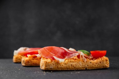 jamon bruschetta prosciutto appetizer portioned tapas dish natural tasty snack fresh delicious gourmet food background on the table rustic top view copy space