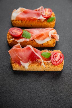 jamon bruschetta prosciutto appetizer portioned tapas dish natural tasty snack fresh delicious gourmet food background on the table rustic top view copy space