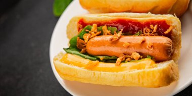 Sosisli kızartılmış soğan, sosis, çörek, fast food lezzetli çerez lezzetli gurme yemek arka planı masanın kırsal kesiminde fotokopi alanı.