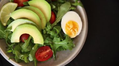 Avokado salatası roka, yumurta, domates, karışık yeşillikler, sebzeler taze gurme yemek arka plan lezzetli yemek masa üstü kırsal yemek fotokopi alanı keto ve paleo diyeti vejetaryen yemeği