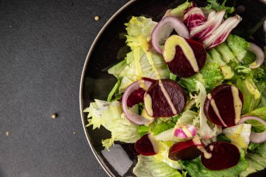 Beet salad green leaf lettuce vegetables natural product tasty snack fresh delicious gourmet food background on the table rustic top view copy space keto and paleo diet vegan and vegan food