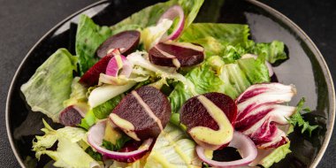 Beet salad green leaf lettuce vegetables natural product tasty snack fresh delicious gourmet food background on the table rustic top view copy space keto and paleo diet vegan and vegan food