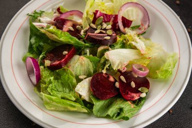 Beet salad green leaf lettuce vegetables natural product tasty snack fresh delicious gourmet food background on the table rustic top view copy space keto and paleo diet vegan and vegan food