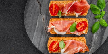 jamon bruschetta prosciutto appetizer portioned tapas dish natural tasty snack fresh delicious gourmet food background on the table rustic top view copy space