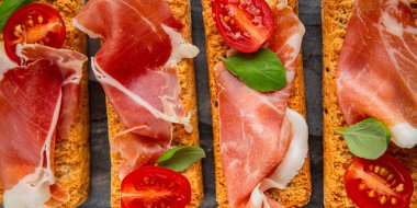 jamon bruschetta prosciutto appetizer portioned tapas dish natural tasty snack fresh delicious gourmet food background on the table rustic top view copy space