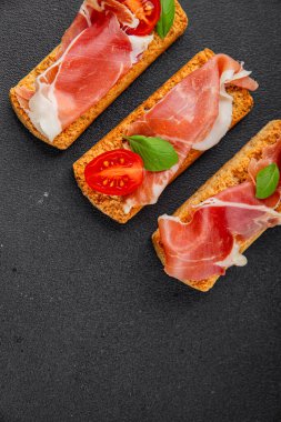 jamon bruschetta prosciutto appetizer portioned tapas dish natural tasty snack fresh delicious gourmet food background on the table rustic top view copy space