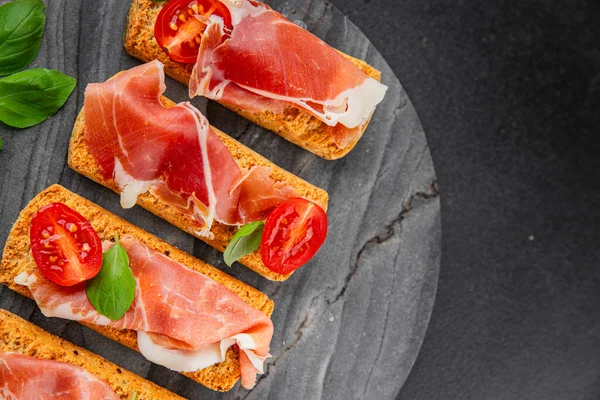 jamon bruschetta prosciutto appetizer portioned tapas dish natural tasty snack fresh delicious gourmet food background on the table rustic top view copy space
