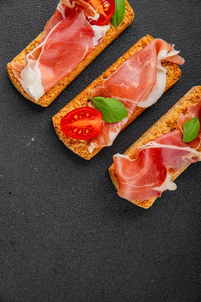 jamon bruschetta prosciutto appetizer portioned tapas dish natural tasty snack fresh delicious gourmet food background on the table rustic top view copy space