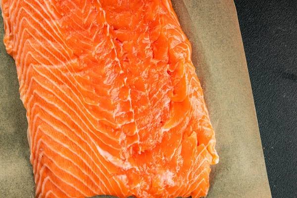 Salmon fillet raw red fish seafood dish natural tasty snack fresh delicious gourmet food background on the table rustic top view copy space pescetarian diet