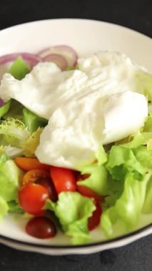 Burrata peyniri domates, mor soğan, yeşil yaprak marul lezzetli aperatif taze gurme yemek masası kırsal yiyeceklerin üst görünümü fotokopi alanı keto ve paleo diyet vejetaryen yemeği.