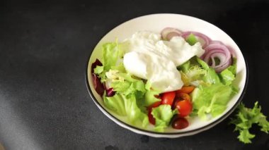Burrata peyniri domates, mor soğan, yeşil yaprak marul lezzetli aperatif taze gurme yemek masası kırsal yiyeceklerin üst görünümü fotokopi alanı keto ve paleo diyet vejetaryen yemeği.