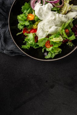 Burrata salatası domates, mor soğan, yeşil yaprak marul lezzetli aperatif taze gurme yemek masası kırsal yemek üst görünüm fotokopi alanı keto ve paleo diyet vejetaryen yemeği.