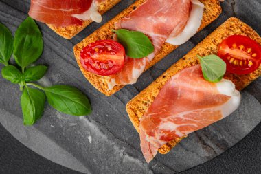 jamon bruschetta prosciutto appetizer portioned tapas dish natural tasty snack fresh delicious gourmet food background on the table rustic top view copy space