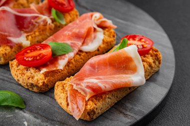 jamon bruschetta prosciutto appetizer portioned tapas dish natural tasty snack fresh delicious gourmet food background on the table rustic top view copy space
