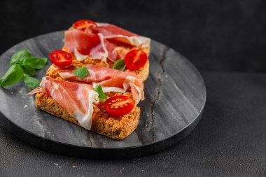 jamon bruschetta prosciutto appetizer portioned tapas dish natural tasty snack fresh delicious gourmet food background on the table rustic top view copy space