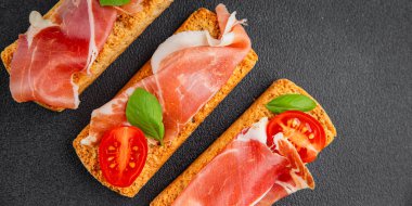 jamon bruschetta prosciutto appetizer portioned tapas dish natural tasty snack fresh delicious gourmet food background on the table rustic top view copy space