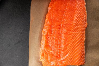 Salmon fillet raw red fish seafood dish natural tasty snack fresh delicious gourmet food background on the table rustic top view copy space pescetarian diet