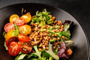 Mercimek salatası sebzeleri, domates, yeşil yaprak marul lezzetli aperatif lezzetli lezzetli gurme yemek masası kırsal üst görünüm fotokopi alanı keto ve paleo diyet vejetaryen ve vejetaryen yemekleri.