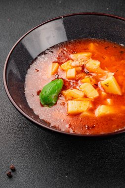 Red soup vegetables potatoes, tomato, broth first course borscht tasty snack fresh delicious gourmet food background on the table rustic food top view copy space keto and paleo diet vegetarian and vegan food