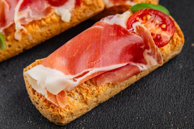 jamon bruschetta prosciutto appetizer portioned tapas dish natural tasty snack fresh delicious gourmet food background on the table rustic top view copy space