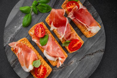 jamon bruschetta prosciutto appetizer portioned tapas dish natural tasty snack fresh delicious gourmet food background on the table rustic top view copy space