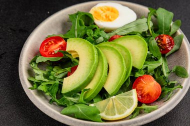 Avokado salatası roka, yumurta, domates, karışık yeşillikler, sebzeler taze gurme yemek arka plan lezzetli yemek masa üstü kırsal yemek fotokopi alanı keto ve paleo diyeti vejetaryen yemeği