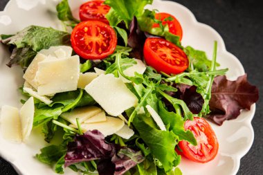 Parmesan peynirli sebze salatası domates, roka, yeşil yaprak marul sağlıklı yemek ana yemek aperatifi taze lezzetli gurme yemek arkaplanı masa rustik yemek üst görünüm uzay keto ve paleo diyet vejetaryen gıda
