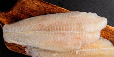 Donmuş balık fileto beyaz balık pangasius deniz ürünleri lezzetli leziz lezzetli gurme lezzetli diyet arka planı masadaki kırsal yemek üst görüşü uzay keto ve paleo diyet