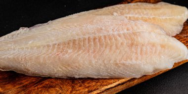Donmuş balık fileto beyaz balık pangasius deniz ürünleri lezzetli leziz lezzetli gurme lezzetli diyet arka planı masadaki kırsal yemek üst görüşü uzay keto ve paleo diyet